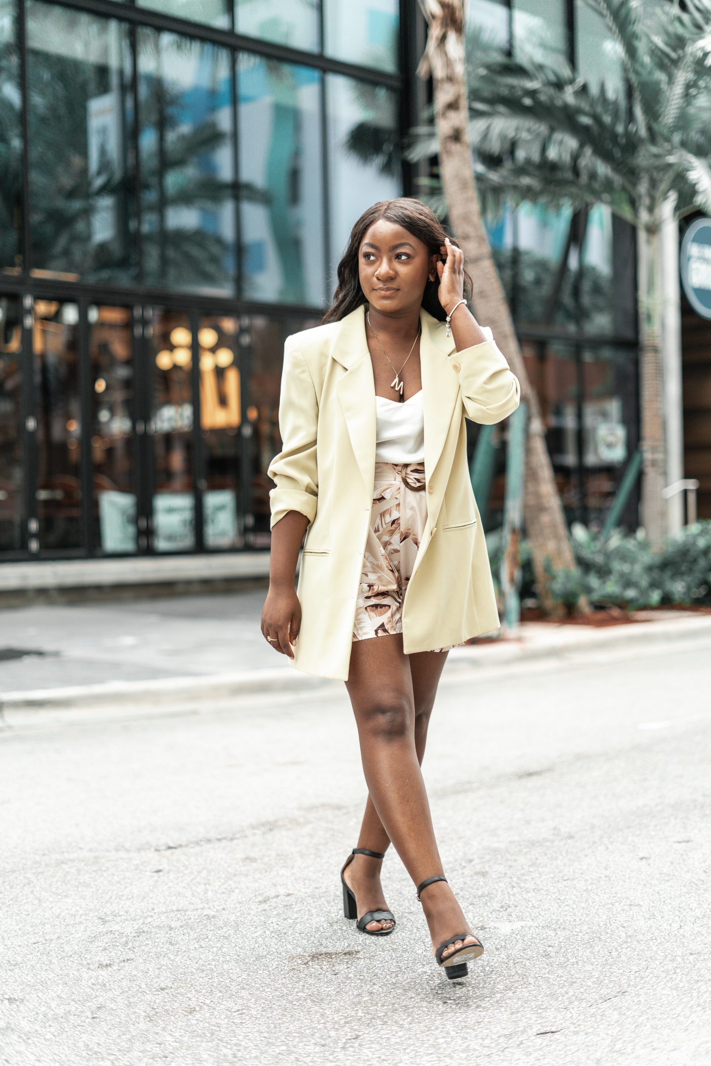 An image of my outfit  wearing the jacket from my wardrobe. Wearing a lime green blazer, white tank and palm print shorts.